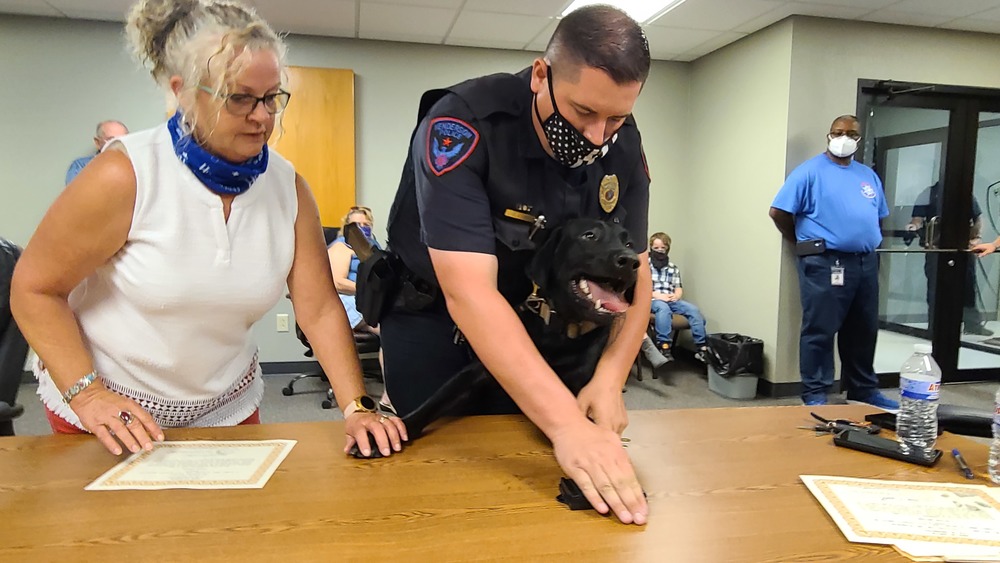 Barney signs his officer certificate